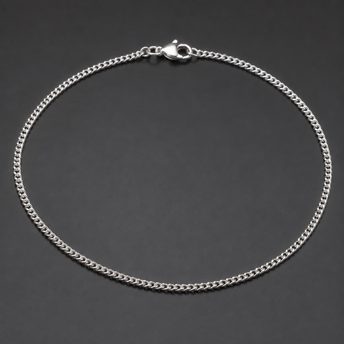Anklet 1.5 mm in solid 925 sterling silver, photographed against a dark grey background
