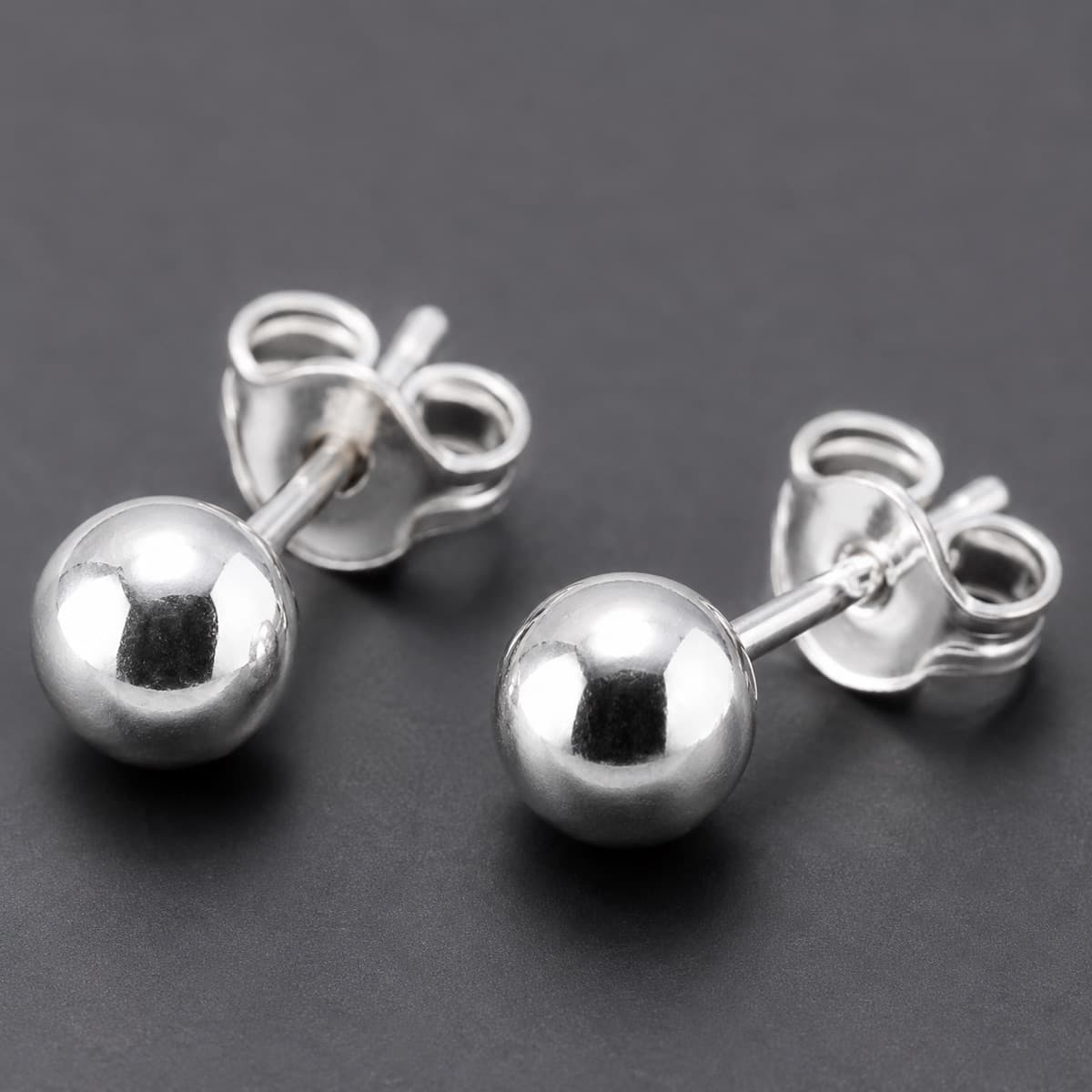 Ball Stud 4 mm Pair in solid 925 sterling silver, photographed against a dark grey background
