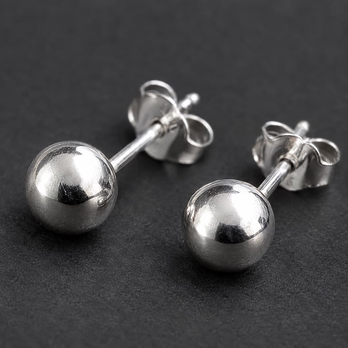 Ball Stud 6 mm Pair in solid 925 sterling silver, photographed against a dark grey background