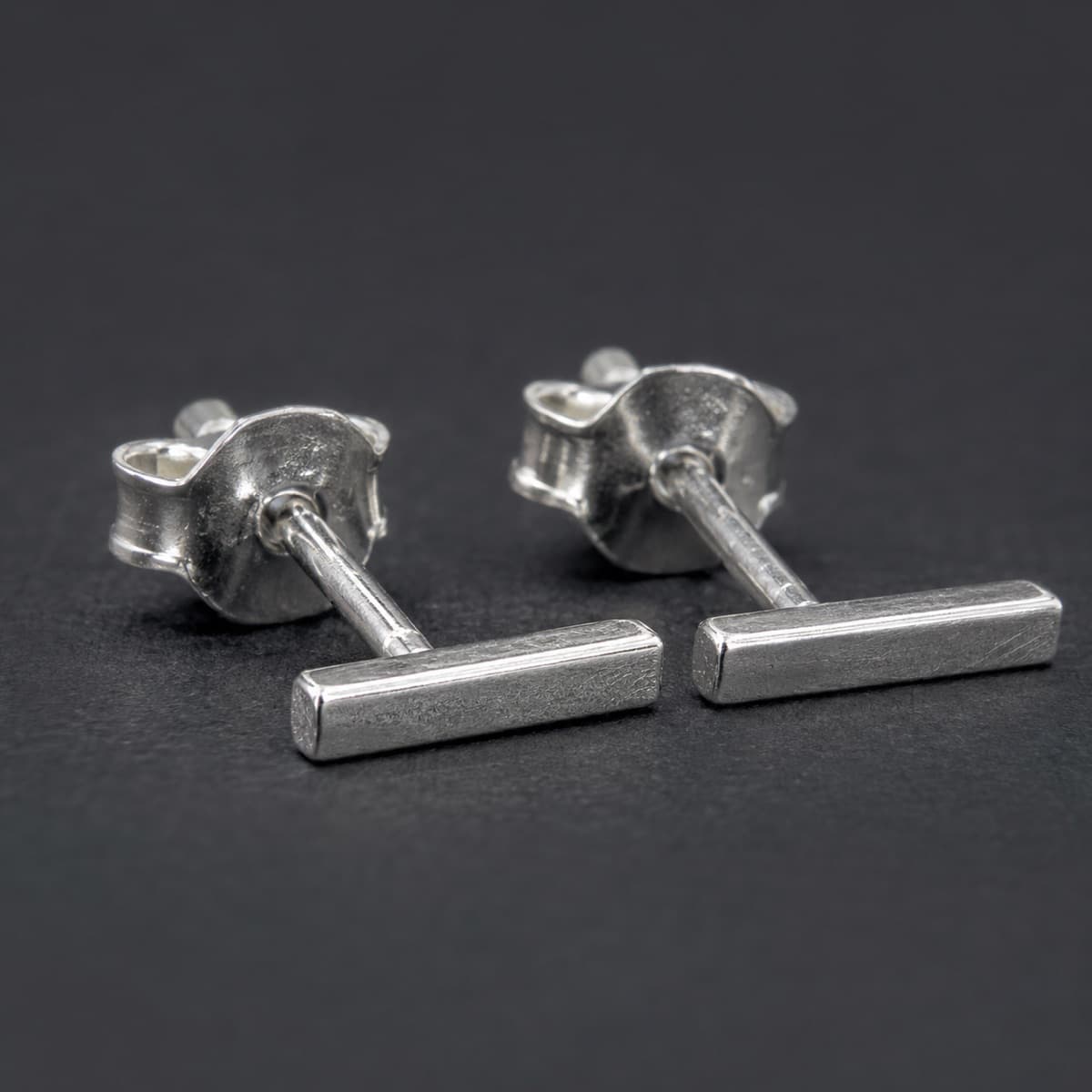 Bar Stud 10 mm Pair in solid 925 sterling silver, photographed against a dark grey background