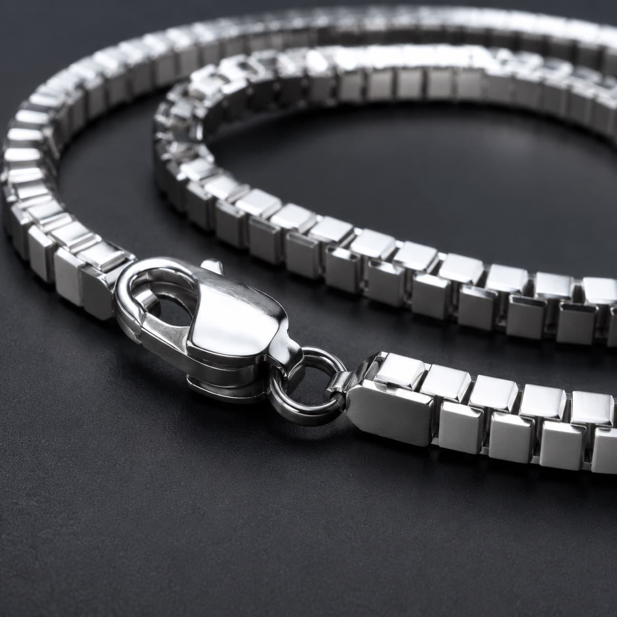Box Bracelet 2 mm in solid 925 sterling silver, photographed against a dark grey background