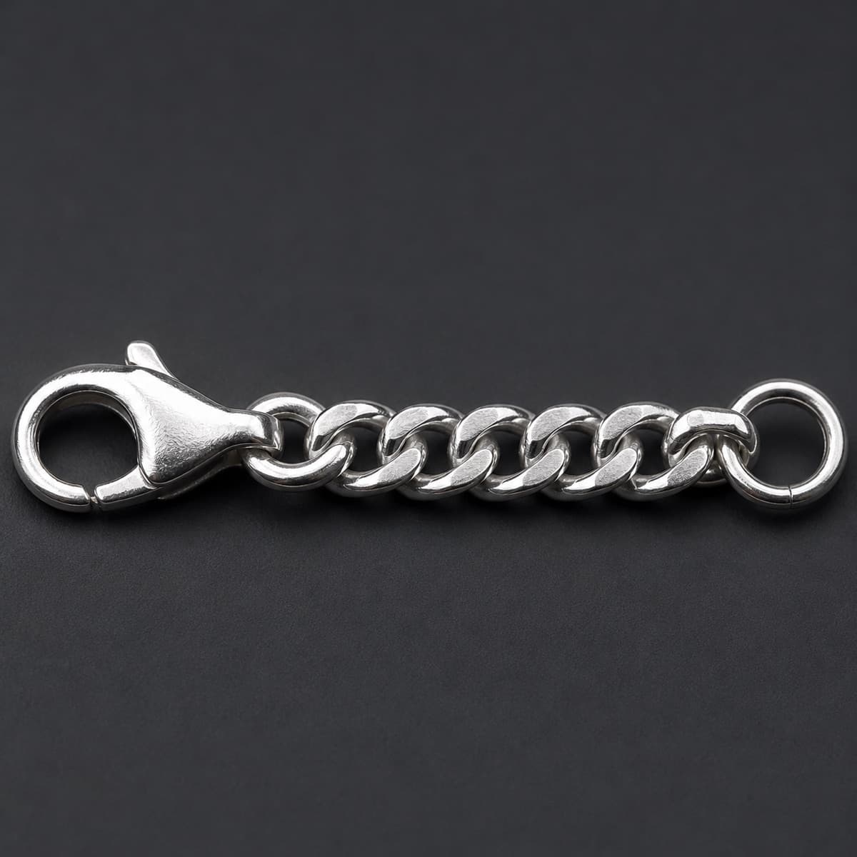 Chain Extender 5 cm in solid 925 sterling silver, photographed against a dark grey background