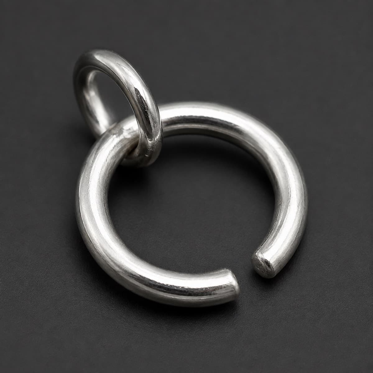 Circle Charm Open 15 mm in solid 925 sterling silver, photographed against a dark grey background