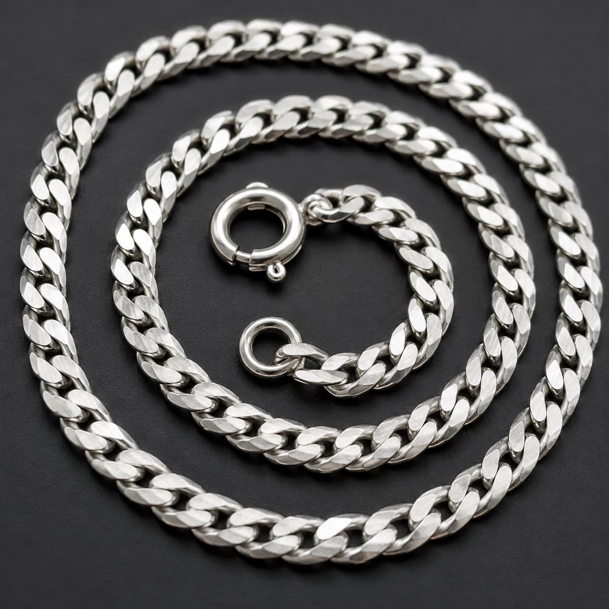 Curb Chain 1.5 mm in solid 925 sterling silver, photographed against a dark grey background