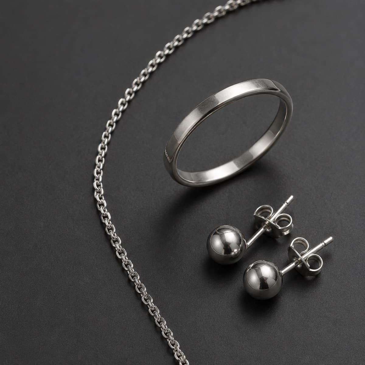 Everyday Trio in solid 925 sterling silver, photographed against a dark grey background