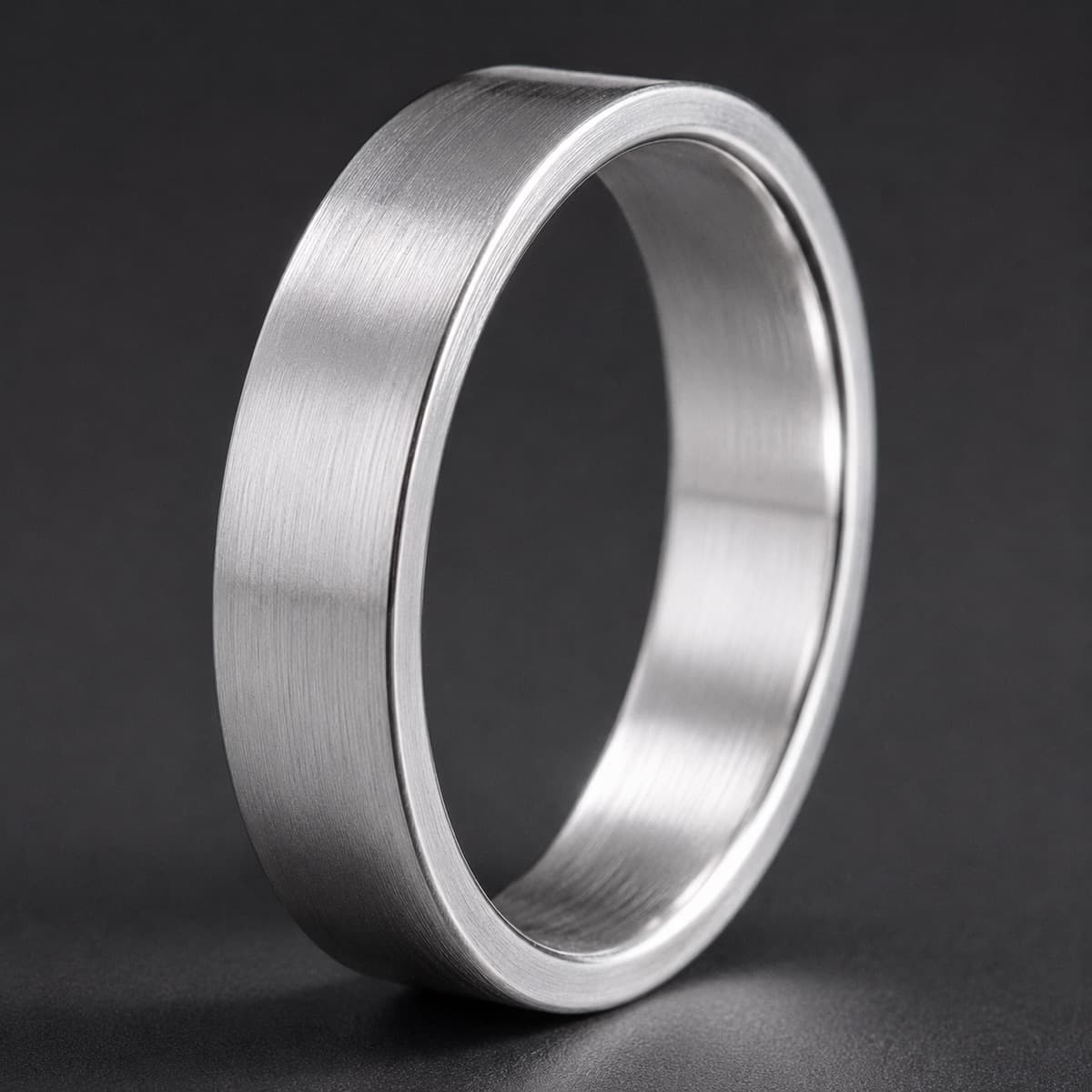 Flat Band 5 mm in solid 925 sterling silver, photographed against a dark grey background