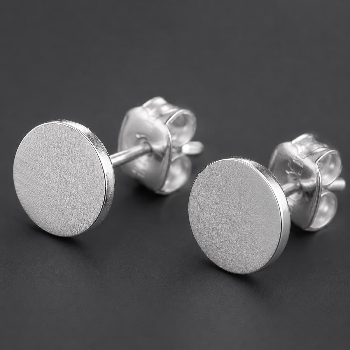 Flat Disc Stud 8 mm Pair in solid 925 sterling silver, photographed against a dark grey background