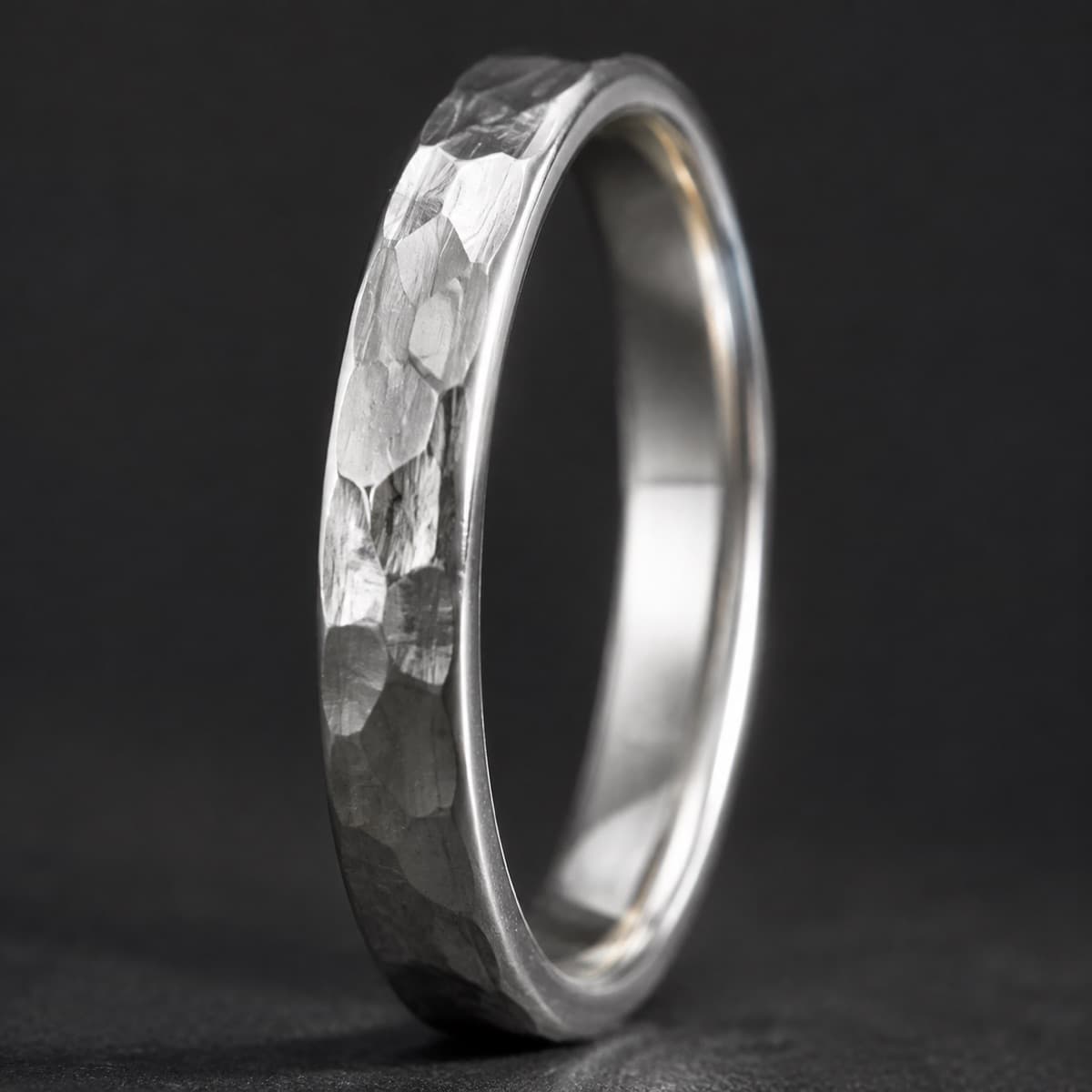 Hammered Band 4 mm in solid 925 sterling silver, photographed against a dark grey background