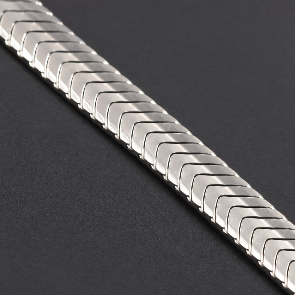 Herringbone Chain 3 mm in solid 925 sterling silver, photographed against a dark grey background