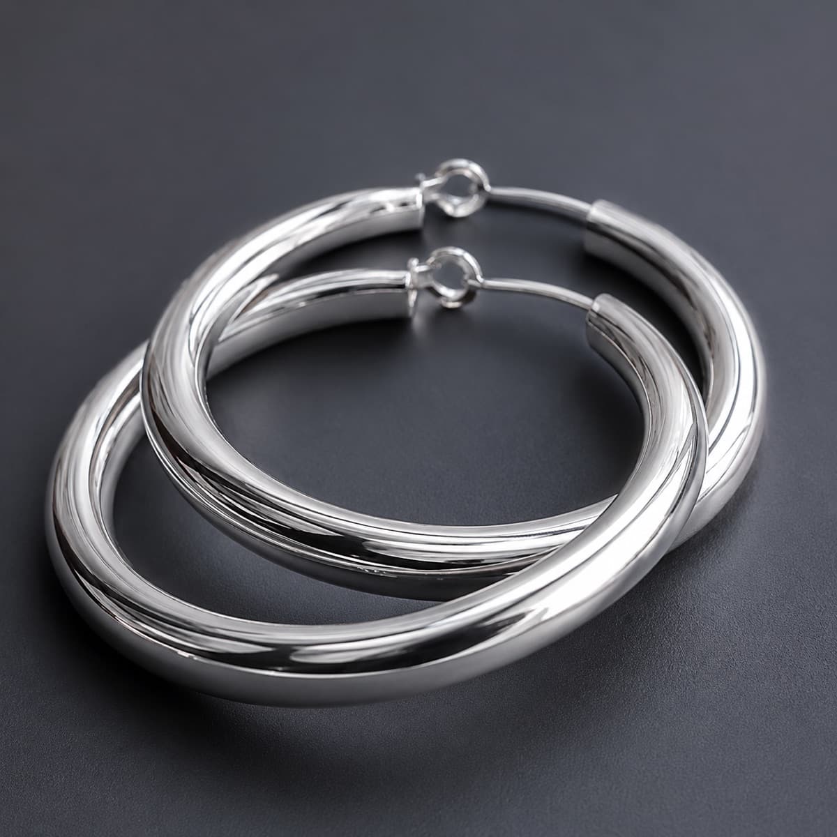 Large Hoop 30 mm Pair in solid 925 sterling silver, photographed against a dark grey background