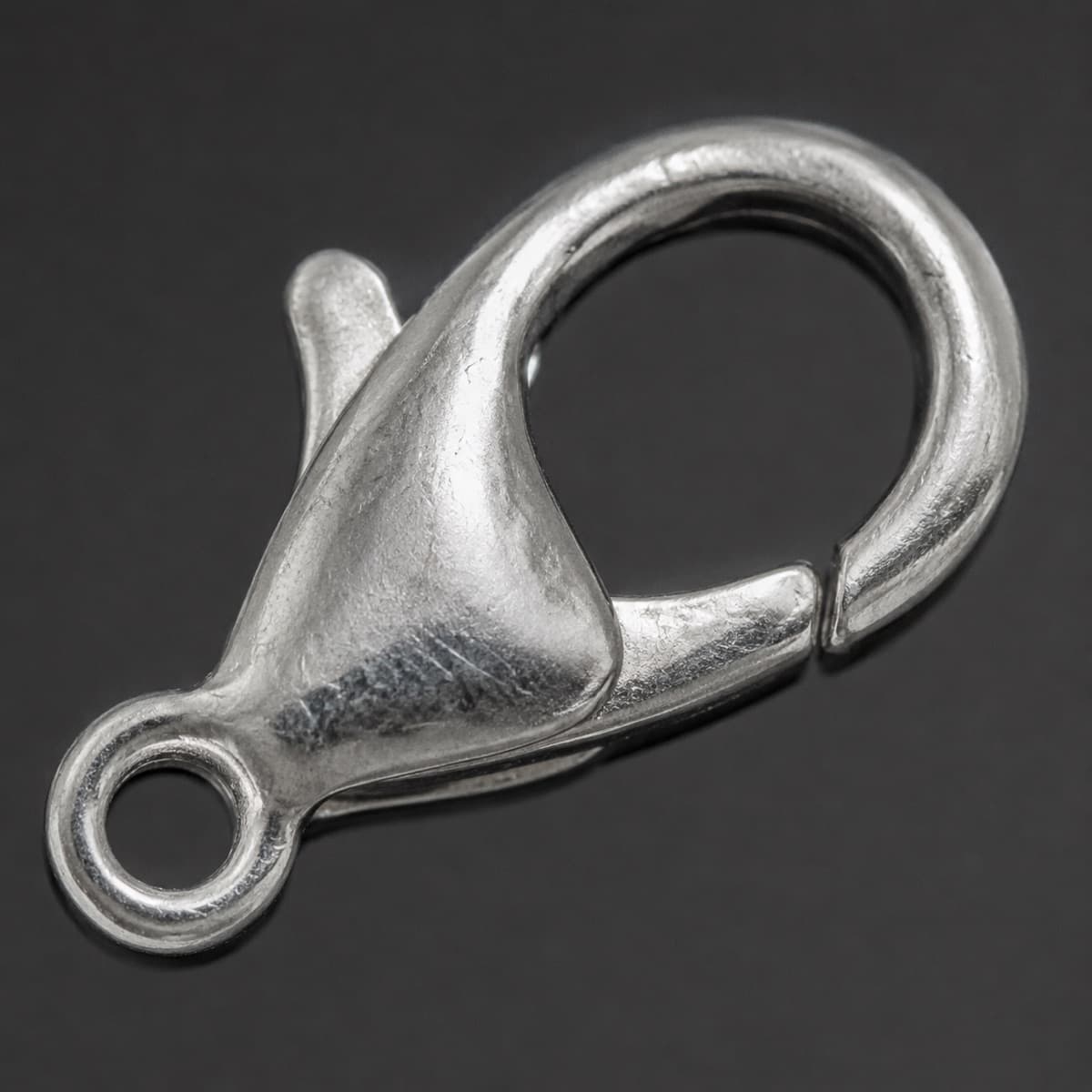 Lobster Clasp Spare in solid 925 sterling silver, photographed against a dark grey background