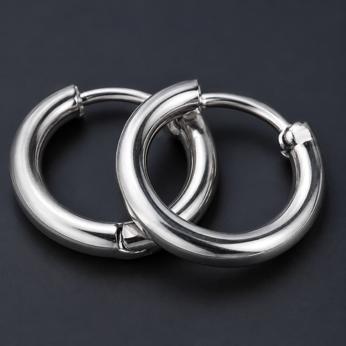 Medium Hoop 20 mm Pair in solid 925 sterling silver, photographed against a dark grey background