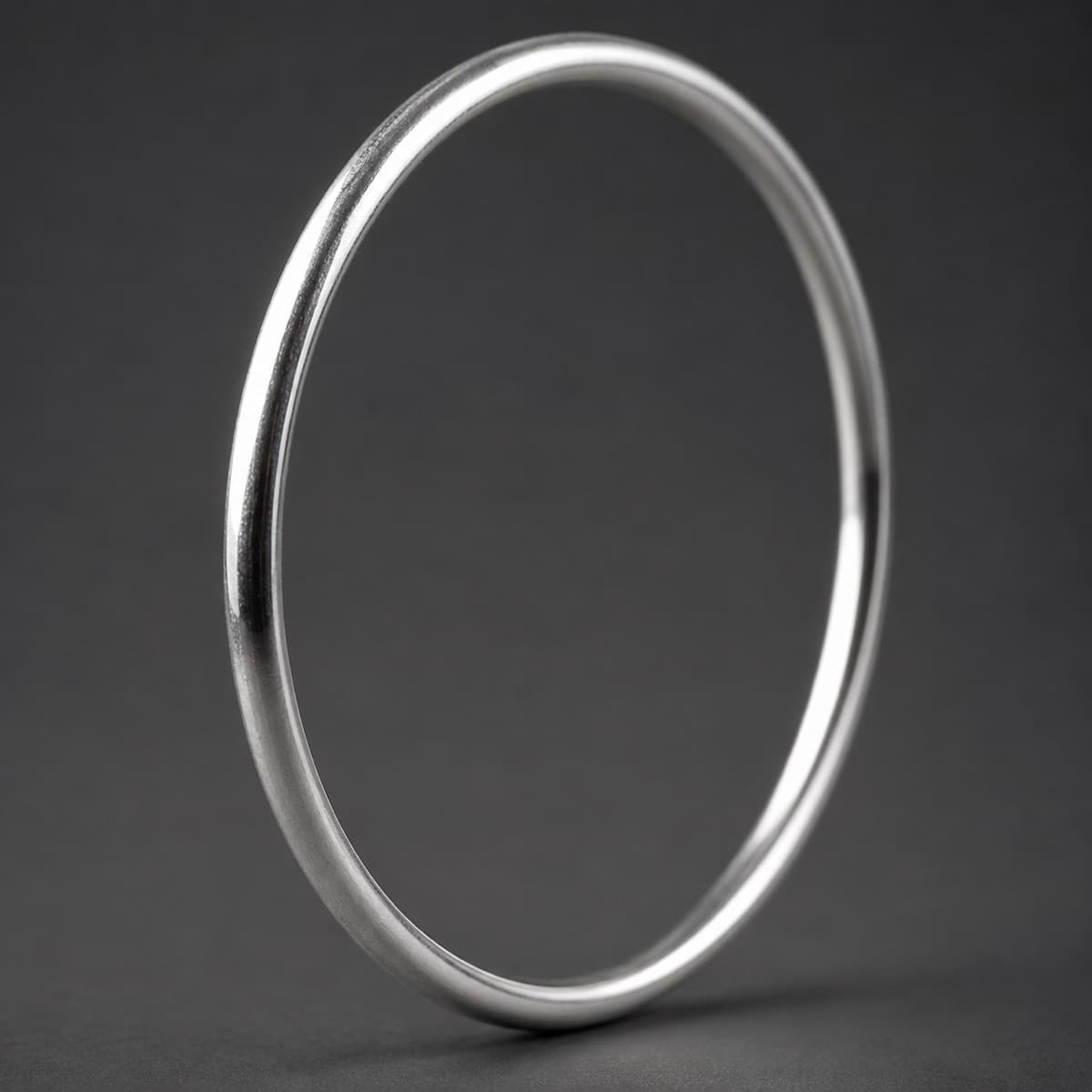 Plain Bangle 3 mm in solid 925 sterling silver, photographed against a dark grey background