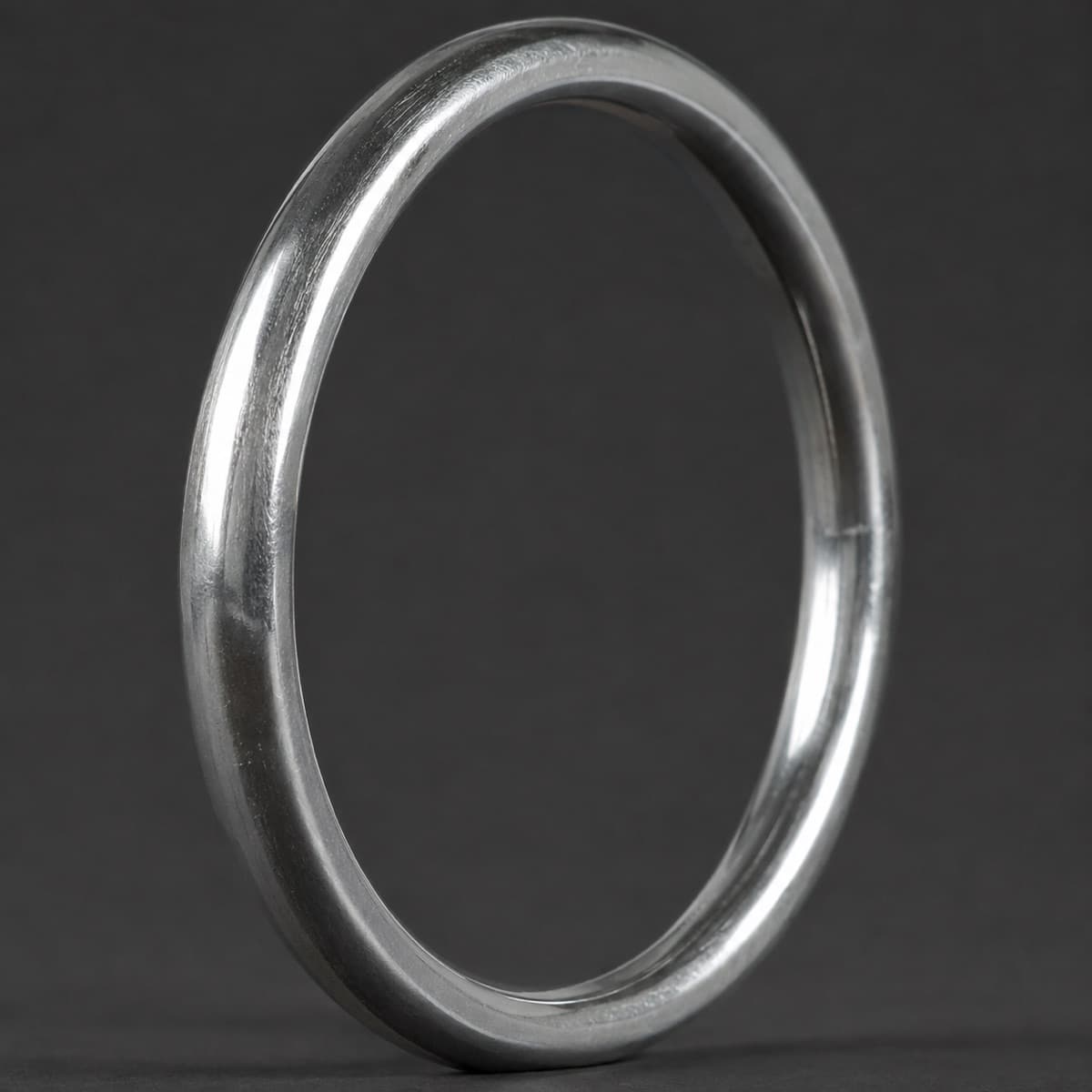 Plain Bangle 5 mm in solid 925 sterling silver, photographed against a dark grey background