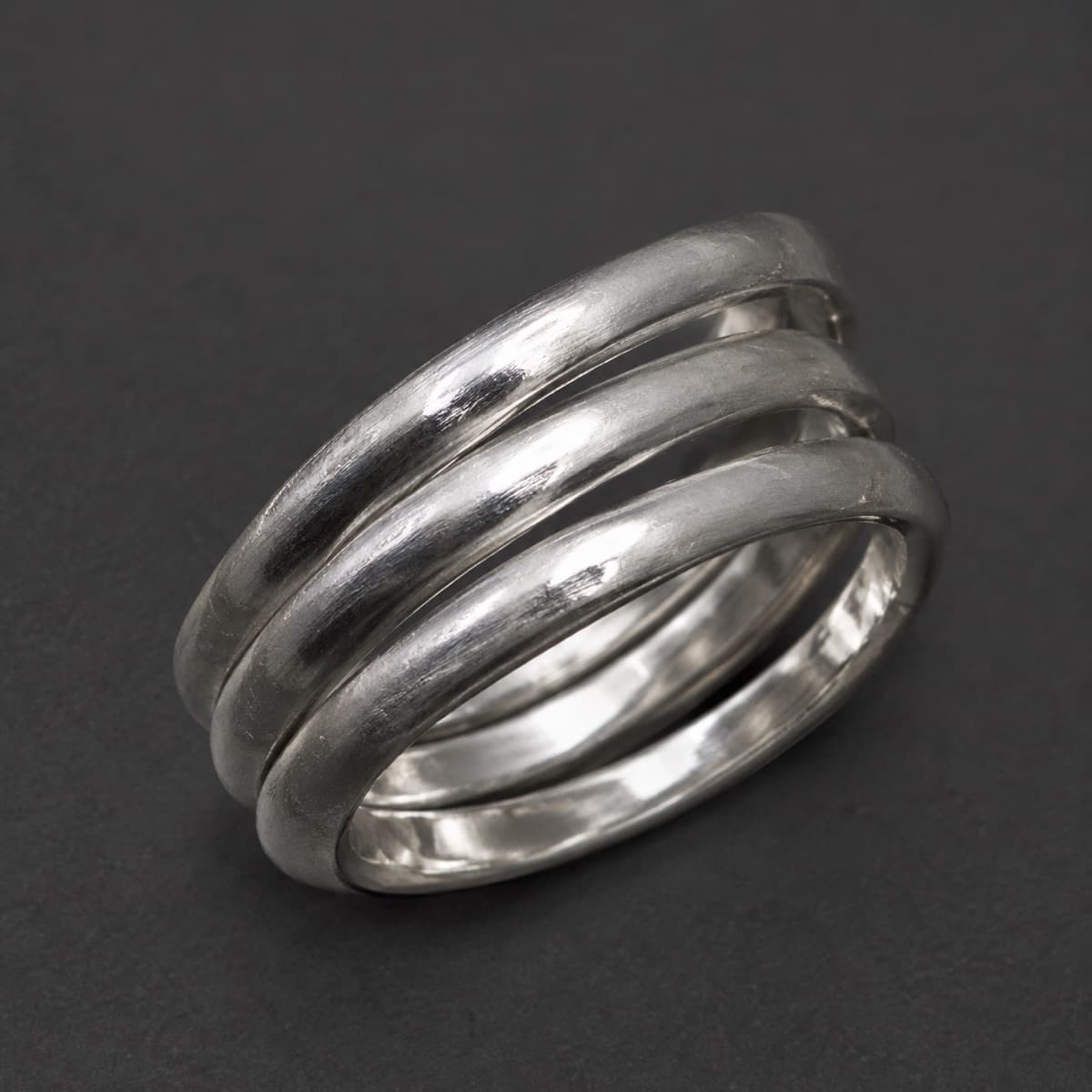 Stacking Ring Trio 1.5 mm in solid 925 sterling silver, photographed against a dark grey background