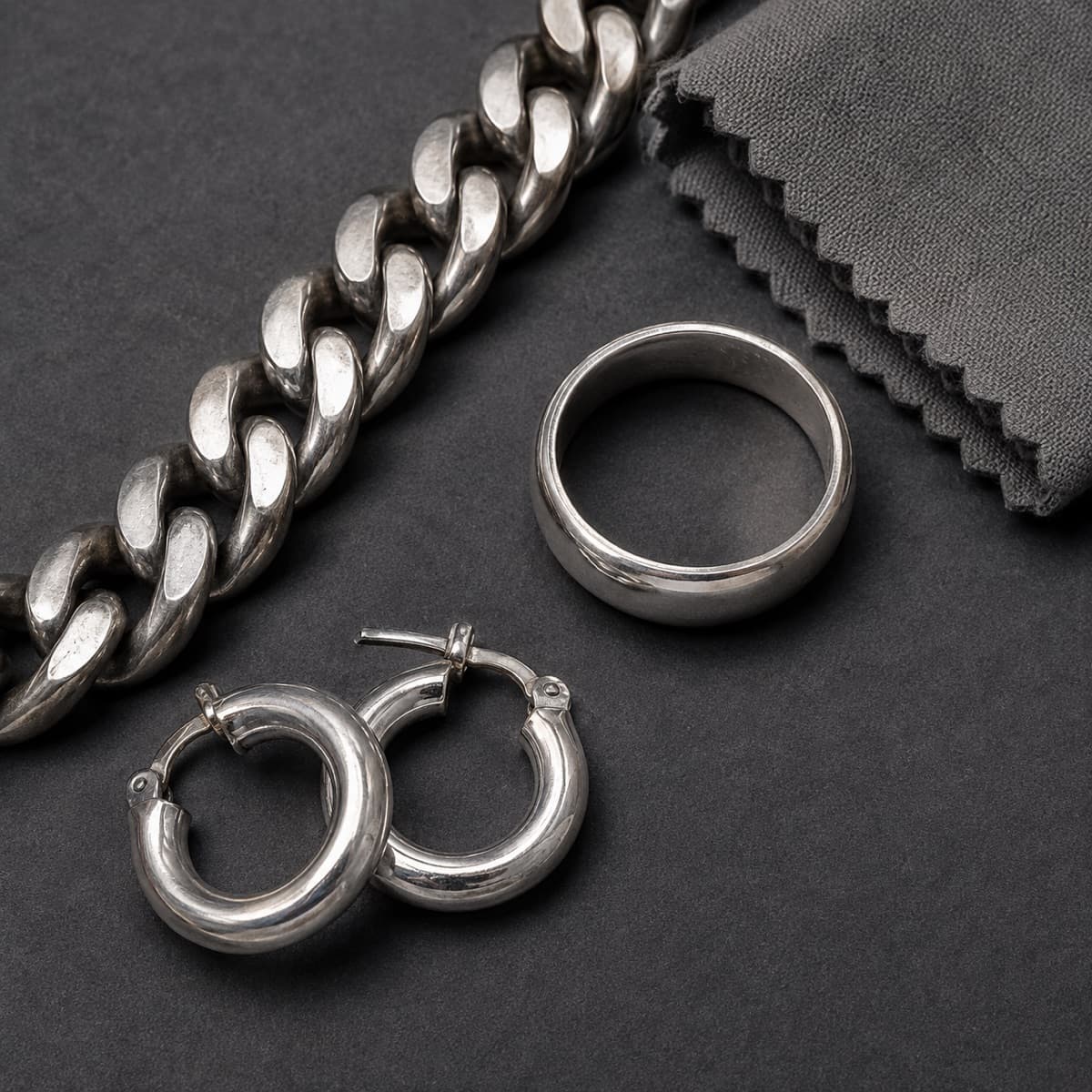 The Worn-In Set in solid 925 sterling silver, photographed against a dark grey background